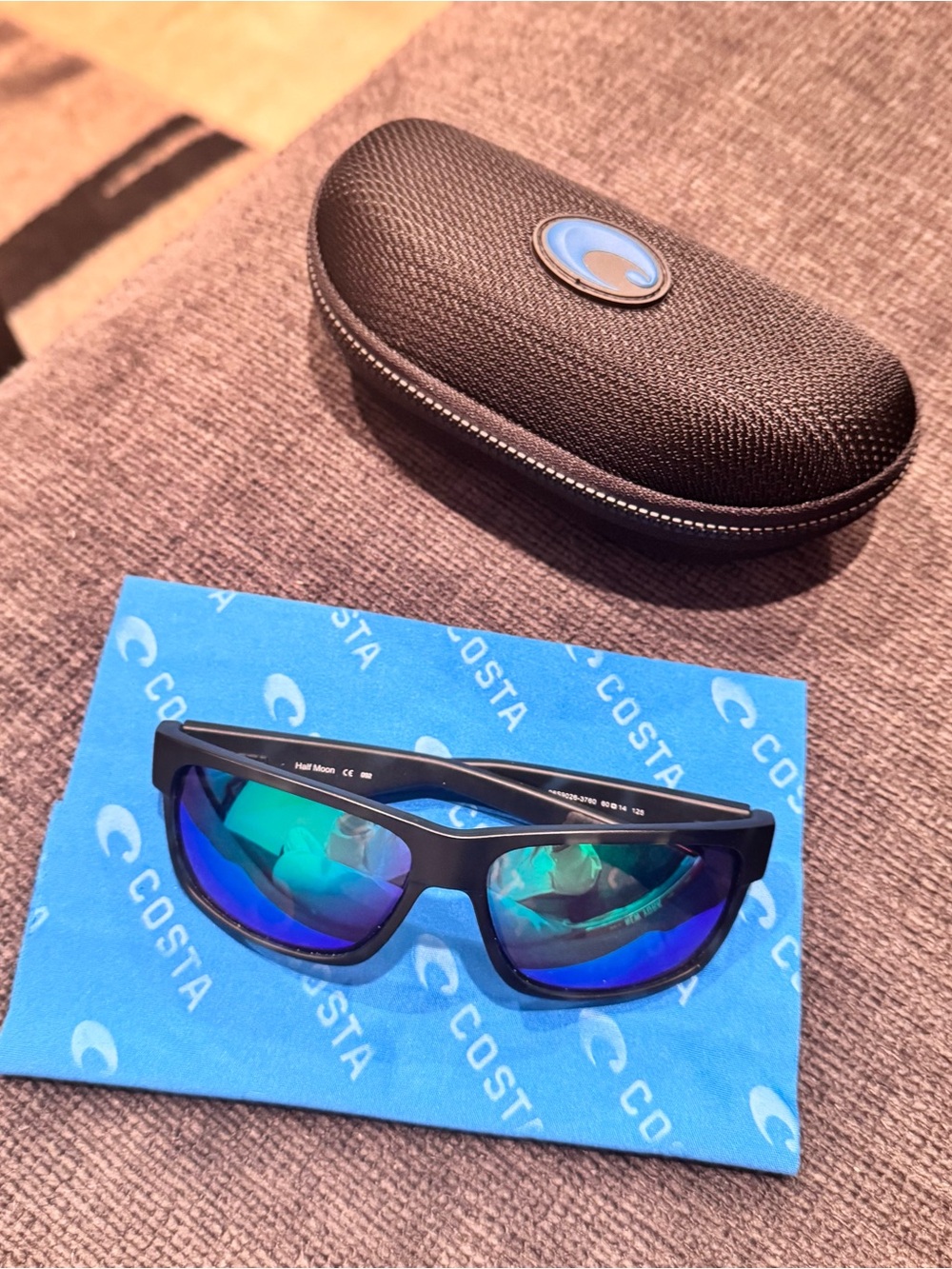Costa ‘half moon’ Sunglasses with Black Frame and Blue-Green Mirrored Lenses